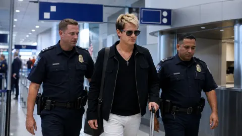 Editorial illustration of Milo Yiannopoulos being escorted through a US airport by immigration officers.
