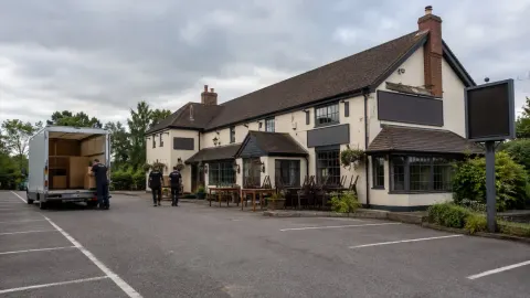 A generic British roadside family pub being emptied on its final day of trading