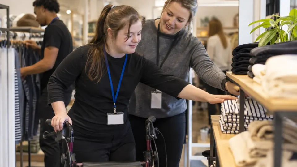 Editorial illustration of an accessible workplace training session for a young disabled employee