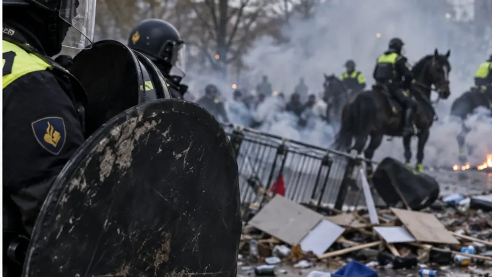 Editorial illustration of police shields and mounted officers amid smoke after a protest in The Hague