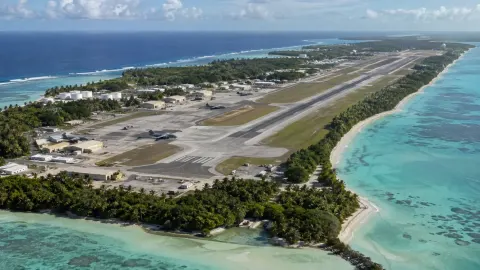 Editorial illustration of the Diego Garcia airfield and lagoon on a tropical atoll