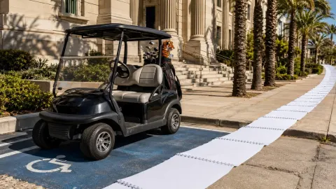 Golf buggy outside a courthouse beside a long trail of calendar pages representing a five-year driving ban.