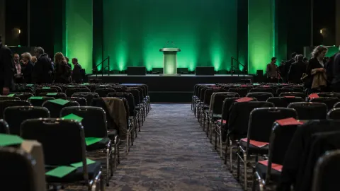 Editorial illustration of a British political conference hall after a contested vote